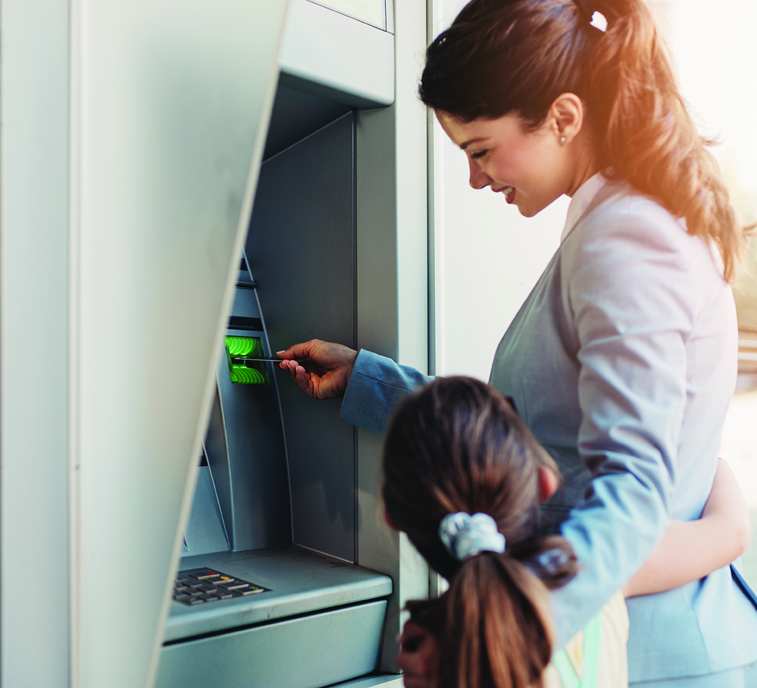 woman using a shared branch atm