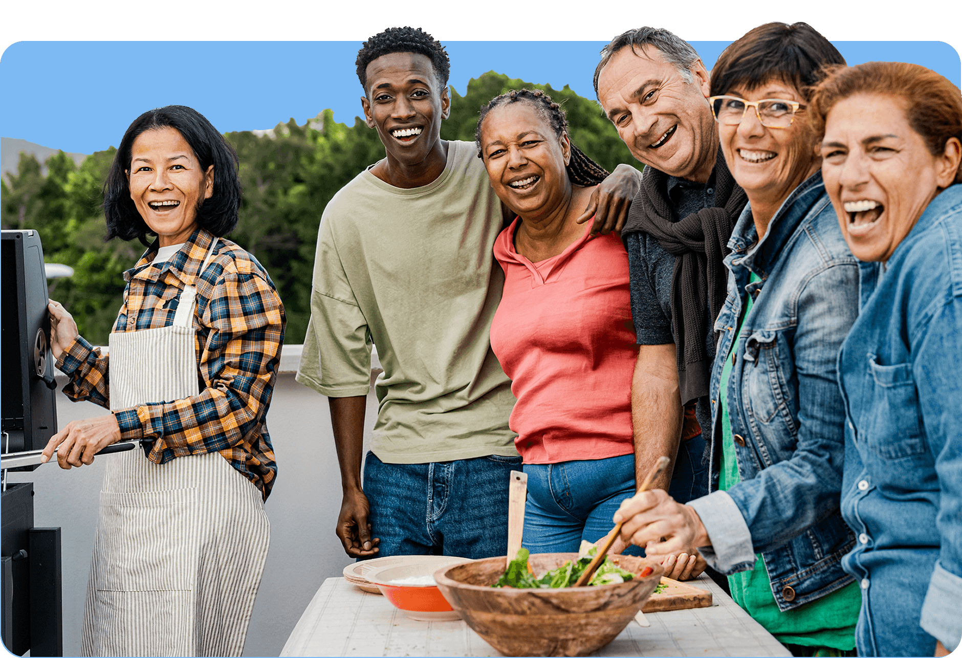 Several people standing together for a photo outside at a barbeque