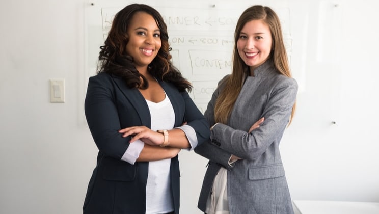 two woman crossing arms