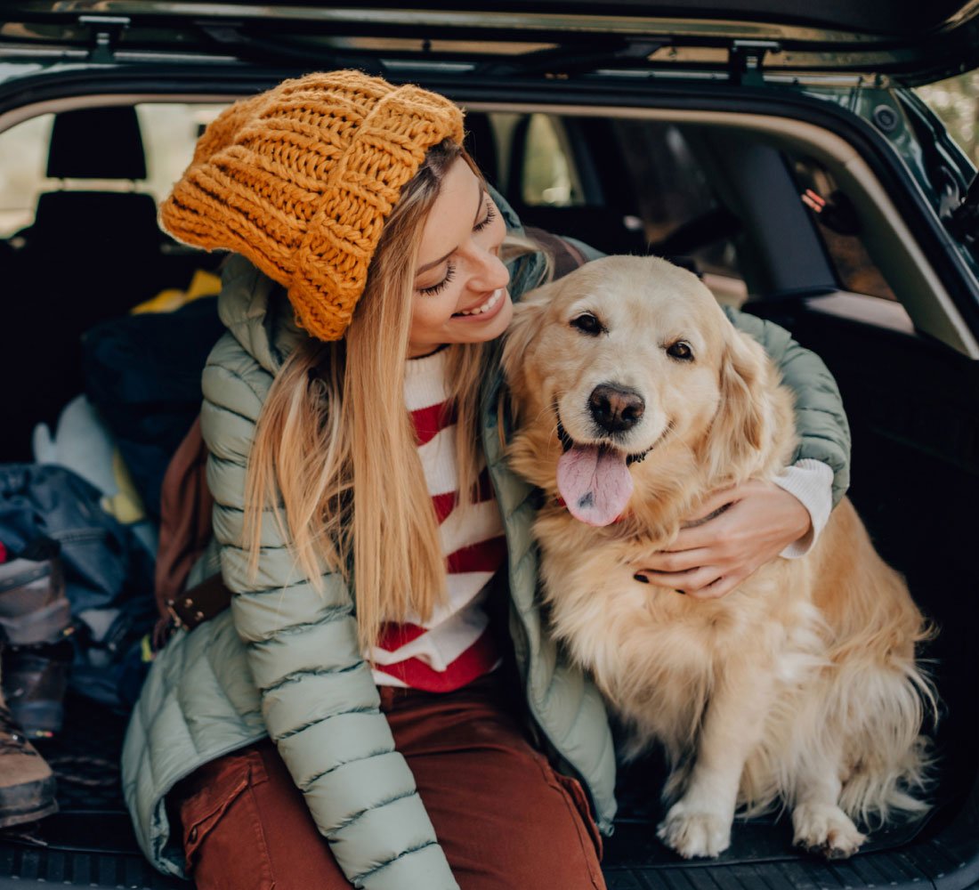 woman with dog in car