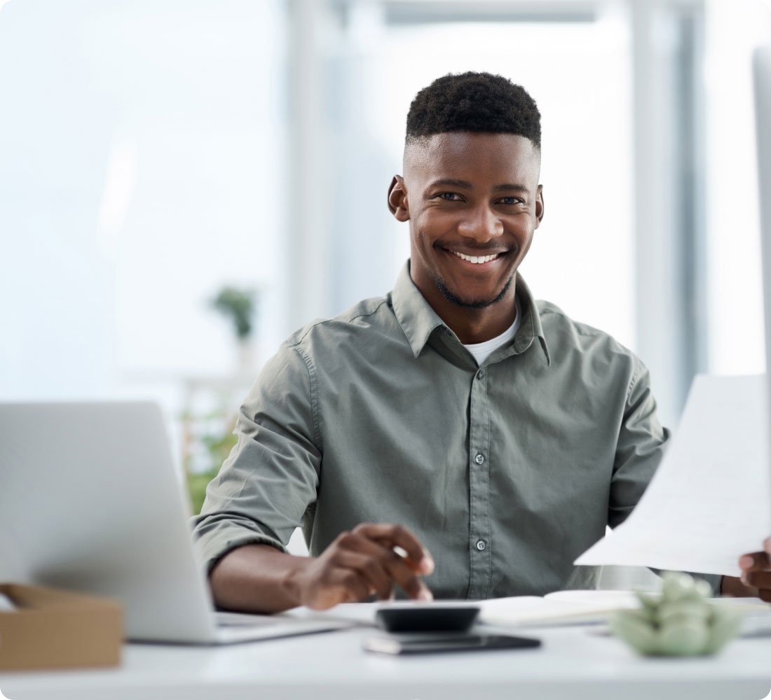 man smiling at desk