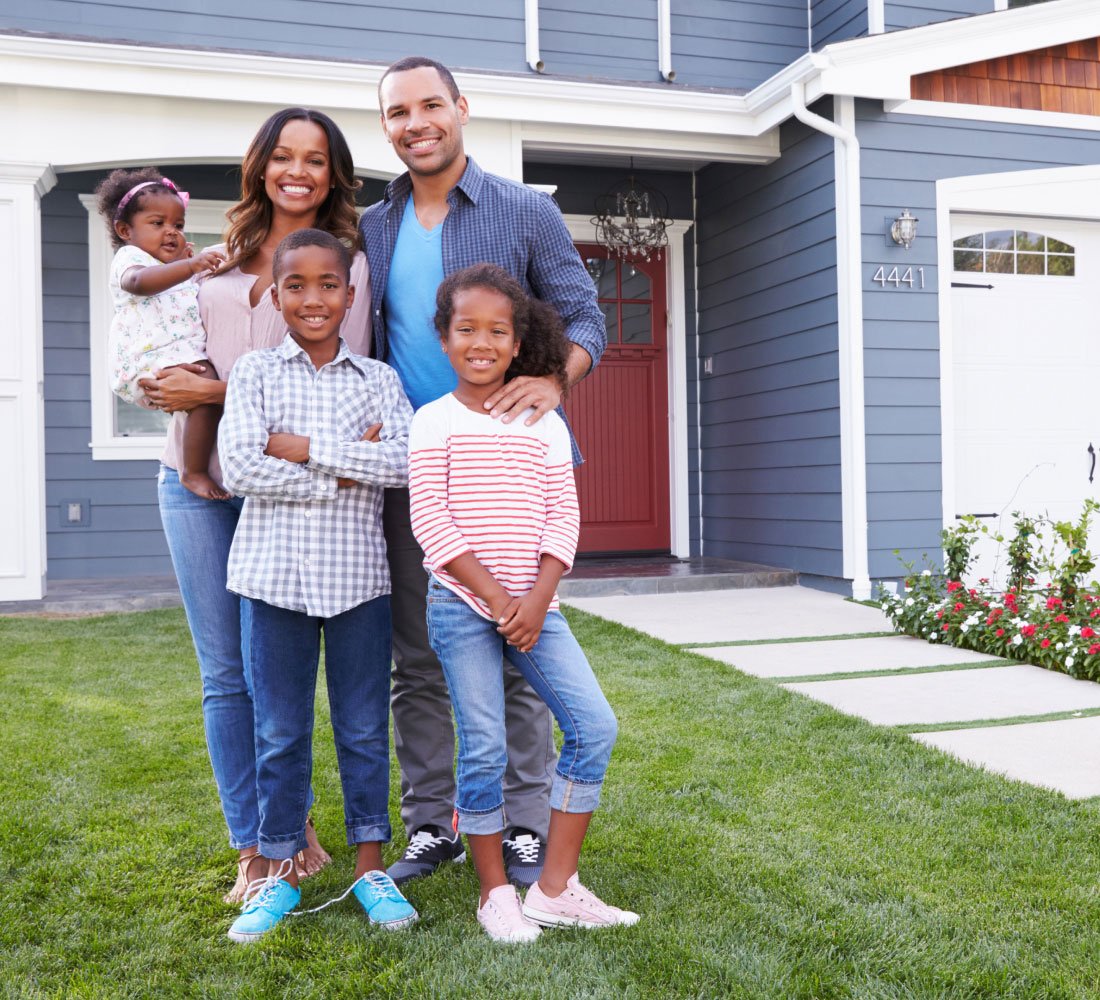 family standing outside home