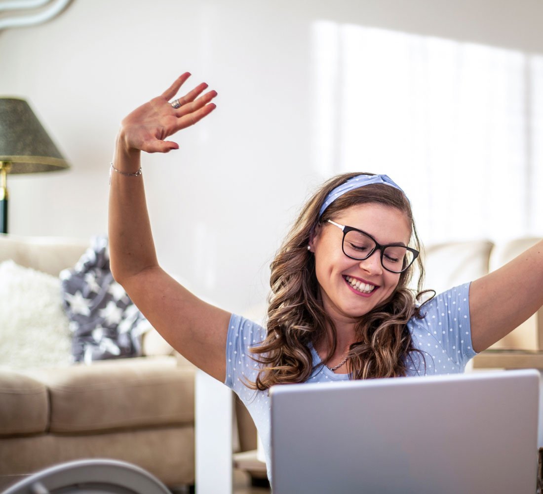 woman at computer happy and smiling